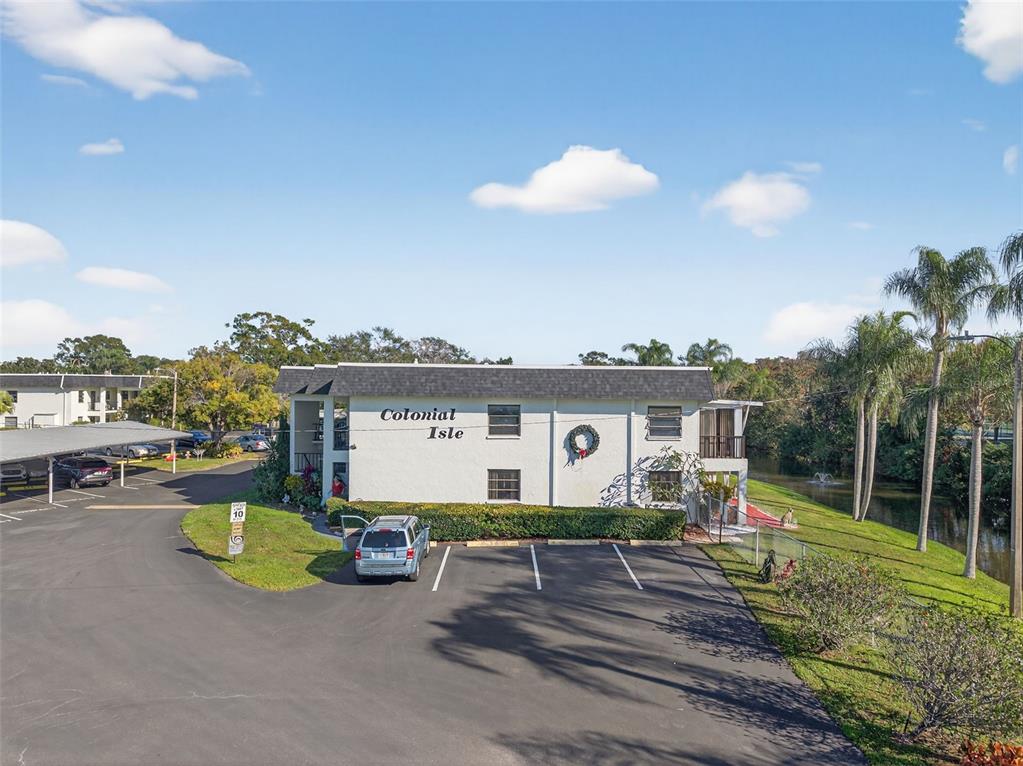 An exterior view of a two-story apartment building named Colonial Isle with a parking lot — 1749 S HIGHLAND AVENUE UNIT A5, CLEARWATER, FL