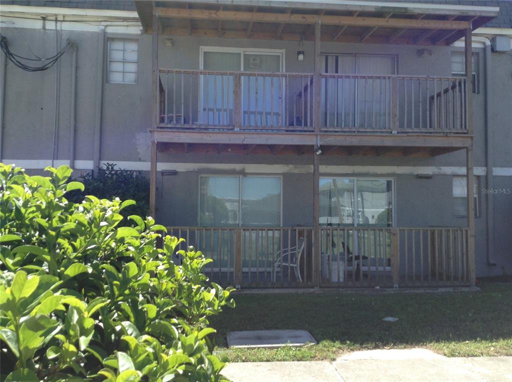 A two-story apartment building exterior features wooden balconies and sliding glass doors on both levels — 2791 L B MCLEOD ROAD UNIT 2791B, ORLANDO, FL