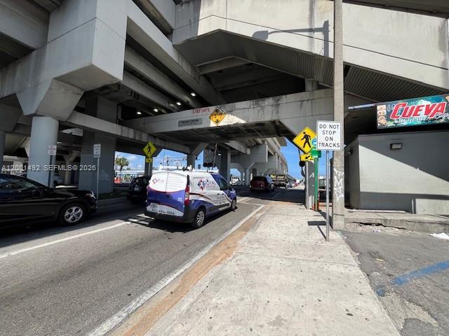 A white van drives under a concrete overpass near a pedestrian crossing sign — 1120 E 25th St, Hialeah FL 33013, HIALEAH, FL