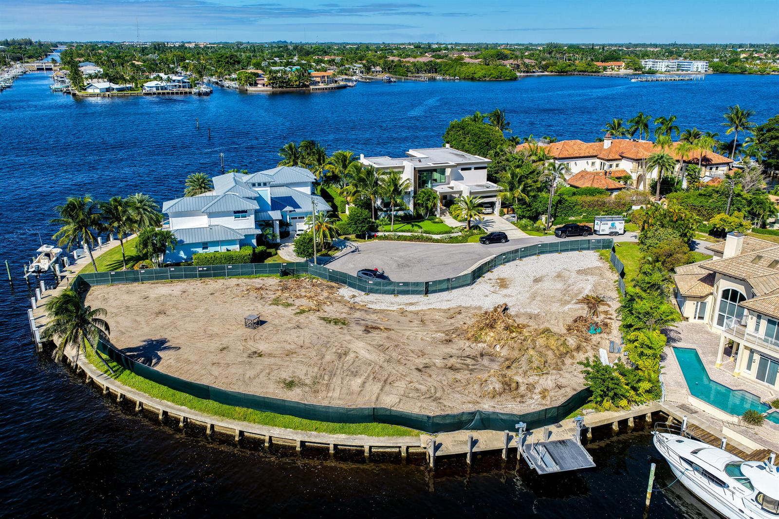 An aerial view of waterfront homes along a canal at sunset — 92 Island Drive S, Ocean Ridge FL 33435, OCEAN RIDGE, FL