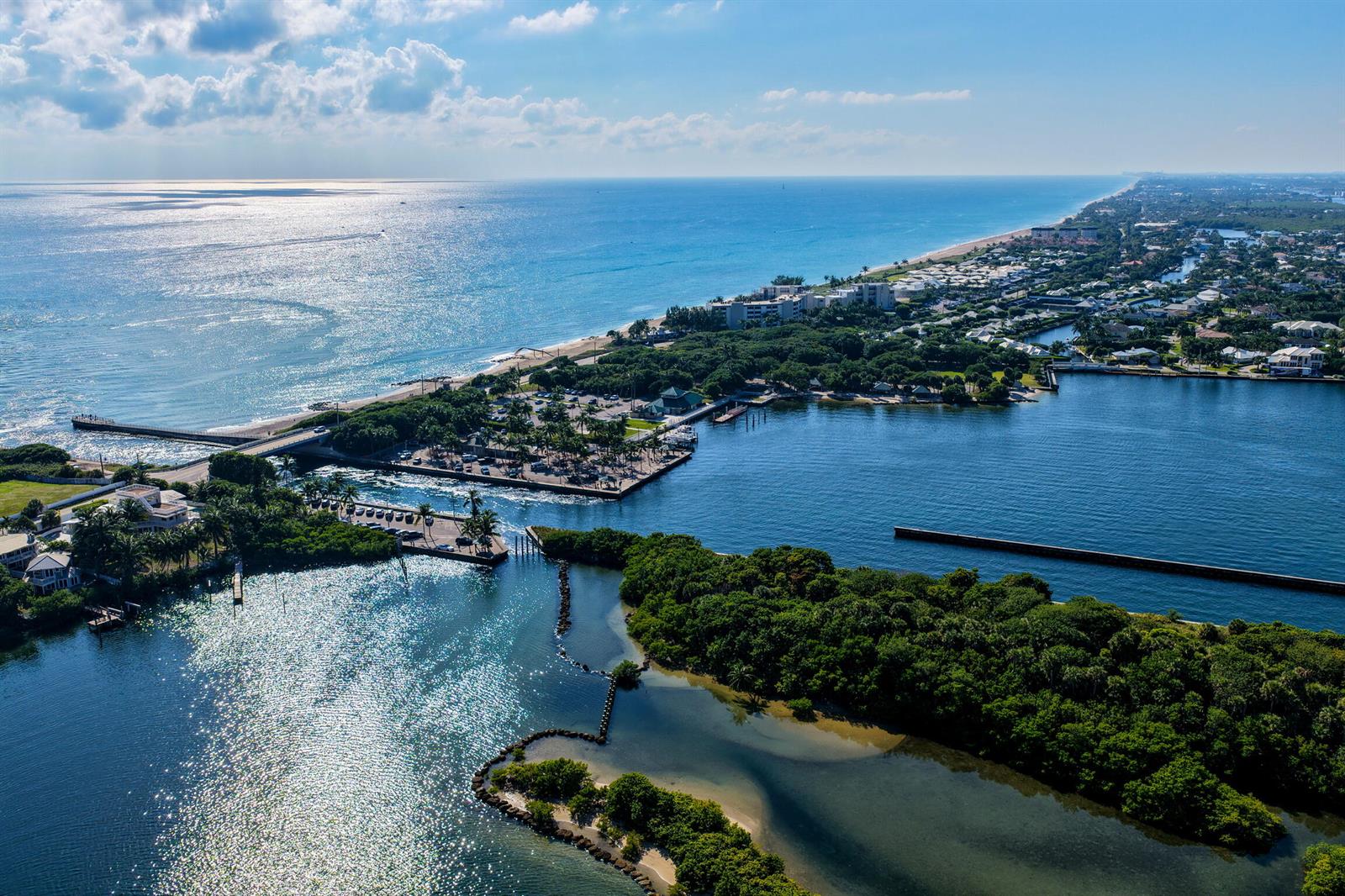 Aerial view of a coastal residential neighborhood featuring waterfront homes, private docks, and lush landscaping — 92 Island Drive S, Ocean Ridge FL 33435, OCEAN RIDGE, FL