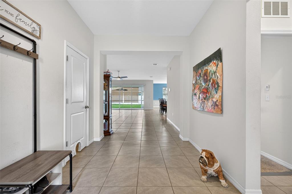 A tiled entryway leads into a living area with a view of the backyard — 13454 GOLDEN LIME AVENUE, SPRING HILL, FL