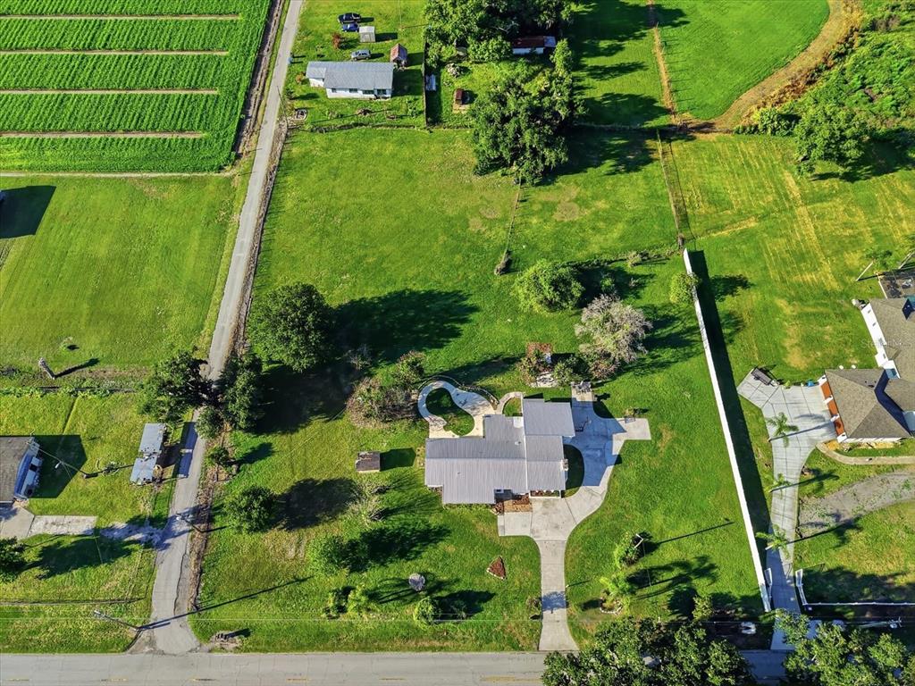 An aerial view shows a house with a pool on a large, grassy rural lot — 1113 COLSON ROAD, PLANT CITY, FL