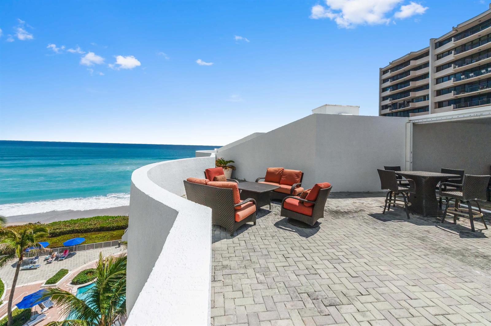 A spacious outdoor patio features wicker furniture, a dining set, and ocean views — 4600 N Ocean Drive # 605, Riviera Beach FL 33404, RIVIERA BEACH, FL