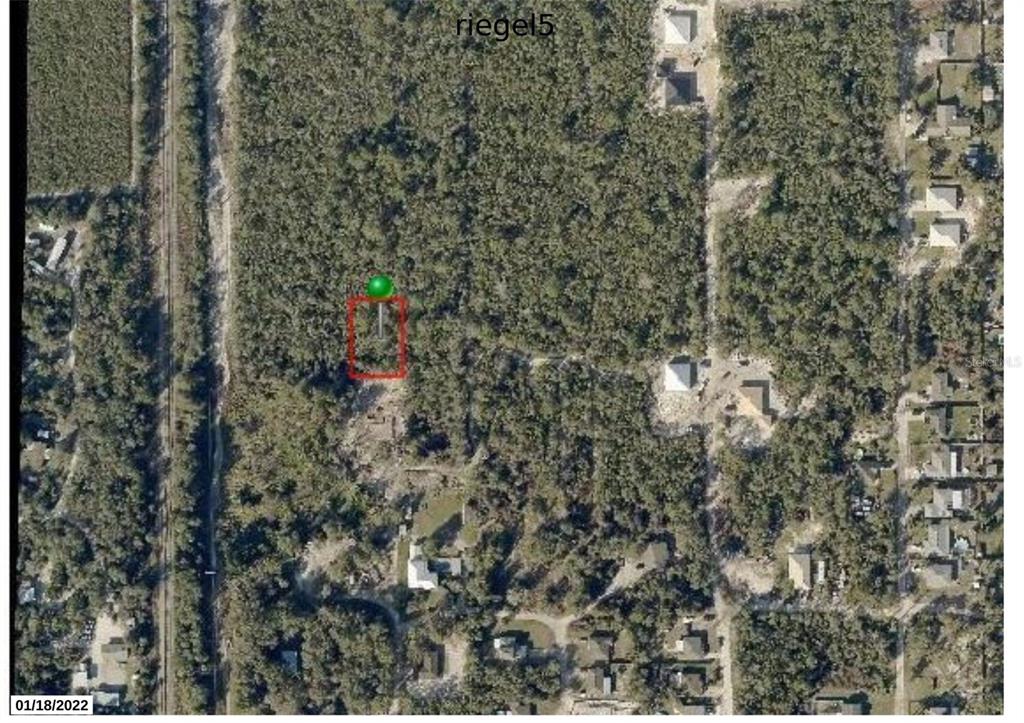 An aerial view shows a rectangular plot of land marked with a red border — RIEGEL (PAPER) AVENUE, ORANGE CITY, FL