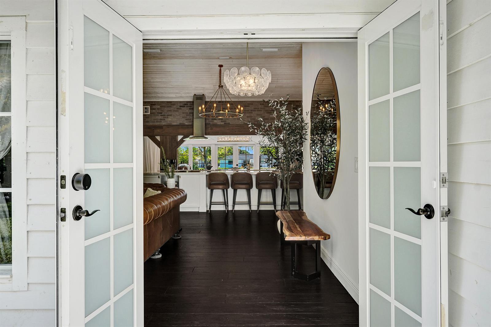 A view through open French doors into a living area with dark wood floors — 271 Oregon Lane, Boca Raton FL 33487, BOCA RATON, FL