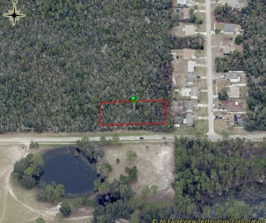 This aerial map shows a rectangular vacant lot outlined in red near a residential street — SIXMA ROAD, DELTONA, FL