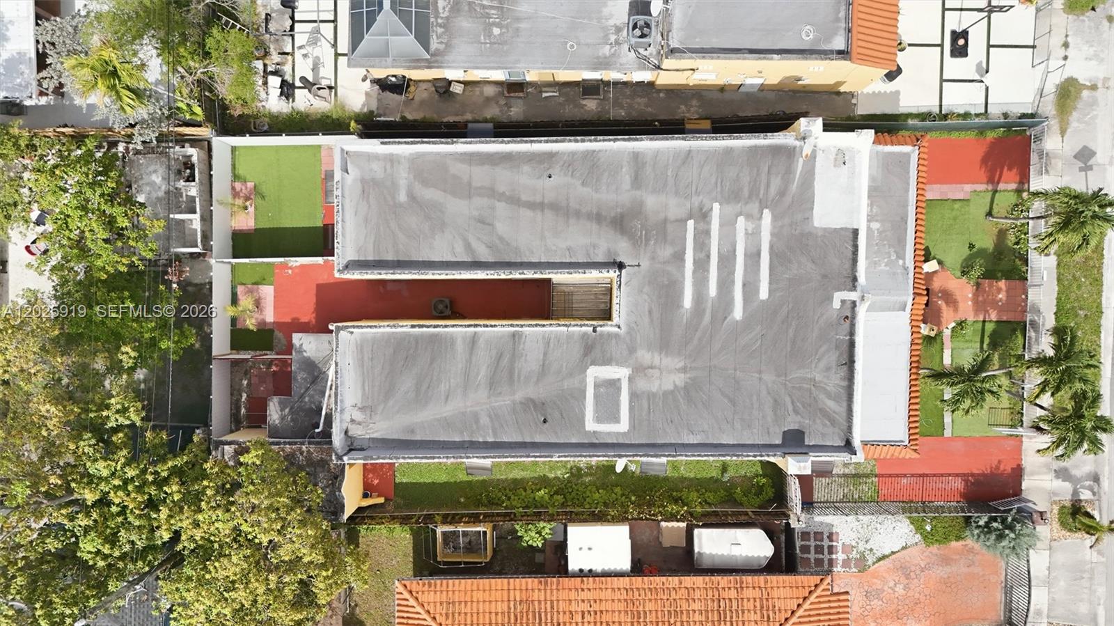 An aerial view shows a flat-roofed building with a central courtyard and surrounding yard space — 1743 SW 17th St # 1, Miami FL 33145, MIAMI, FL