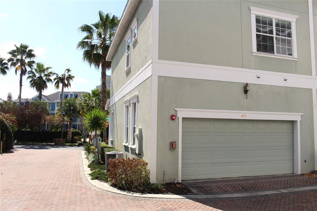 A light green two-story townhouse with a two-car garage and palm trees nearby — 455 OLD FARM LANE, WINTER SPRINGS, FL