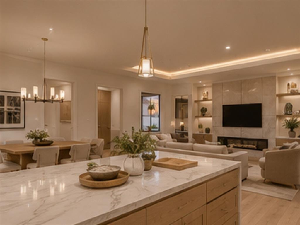 A modern kitchen island with a marble countertop overlooks an open-concept living and dining area — 15148 INGRAHAM BOULEVARD, PORT CHARLOTTE, FL