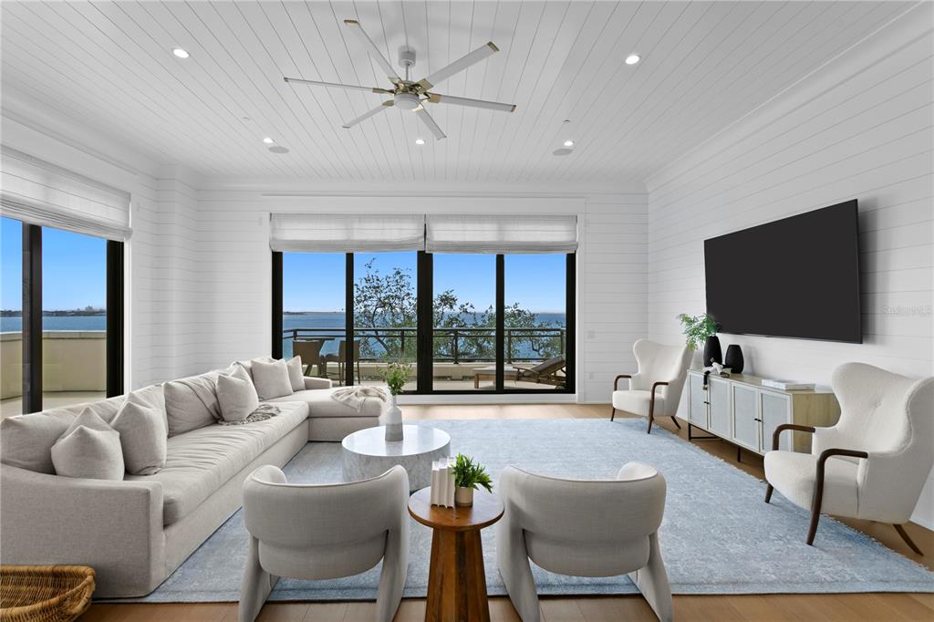 A bright living room features white shiplap walls, a large sectional, and floor-to-ceiling water views — 2103 BAYSHORE BOULEVARD UNIT 504, TAMPA, FL