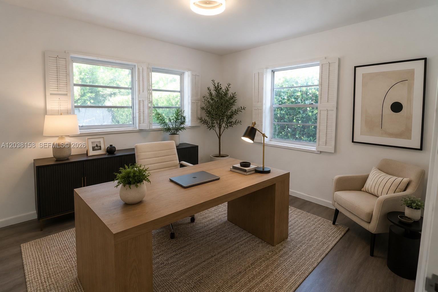 A home office features a wooden desk, a beige armchair, and windows with white shutters — 8025 SW 62nd Pl, Miami FL 33143, MIAMI, FL