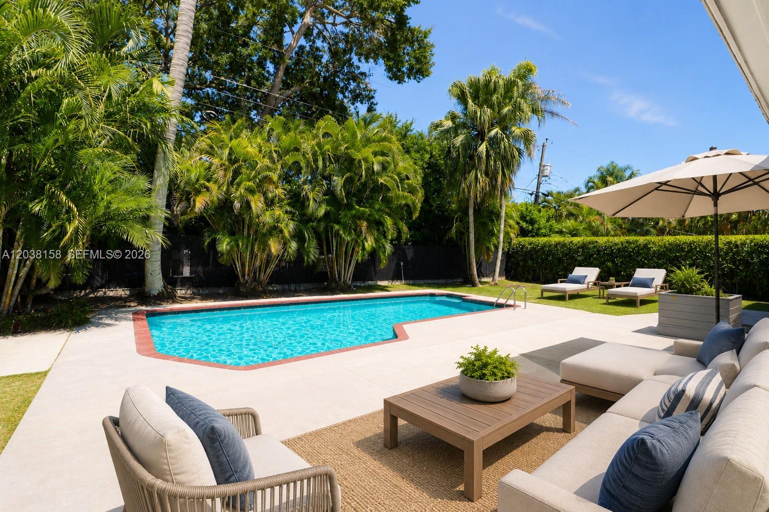 A backyard features a swimming pool, patio furniture, palm trees, and a beige umbrella — 8025 SW 62nd Pl, Miami FL 33143, MIAMI, FL
