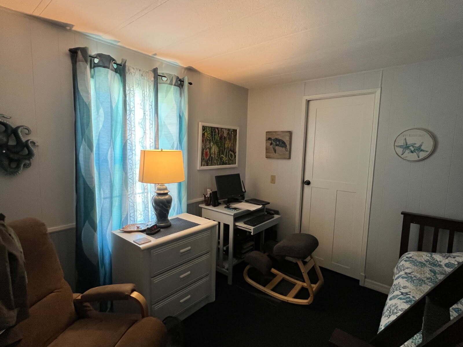 A bedroom features a dresser with a lamp, a computer desk, and a kneeling chair — 304 Mockingbird Avenue, Fort Pierce FL 34982, FORT PIERCE, FL