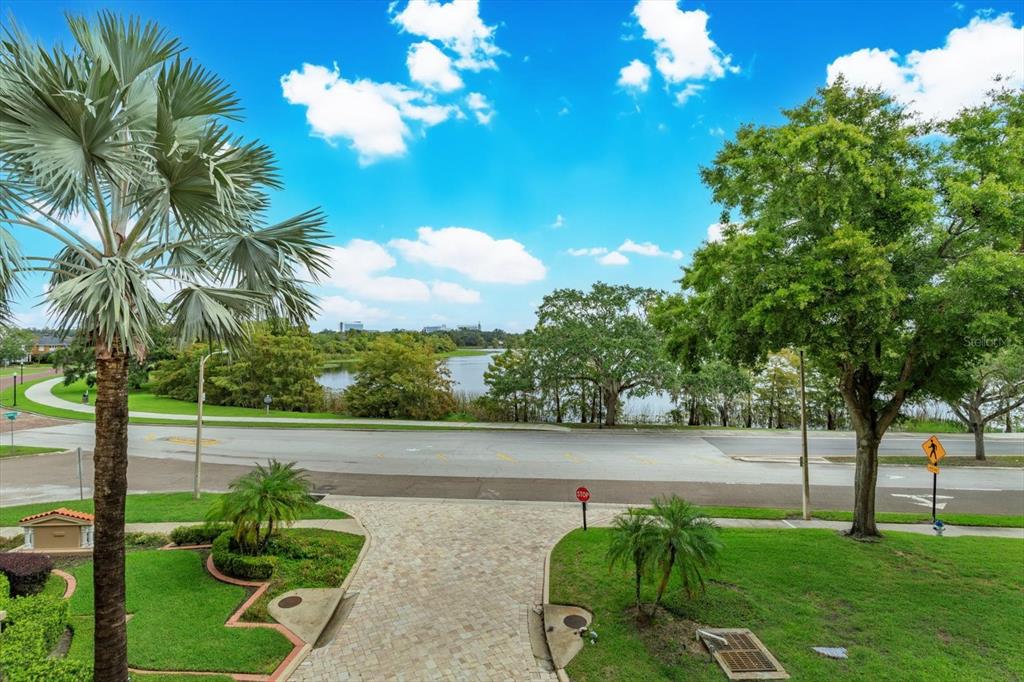 An elevated view of a paved driveway, a street, a lake, and surrounding trees — 1110 W IVANHOE BOULEVARD UNIT 9, ORLANDO, FL