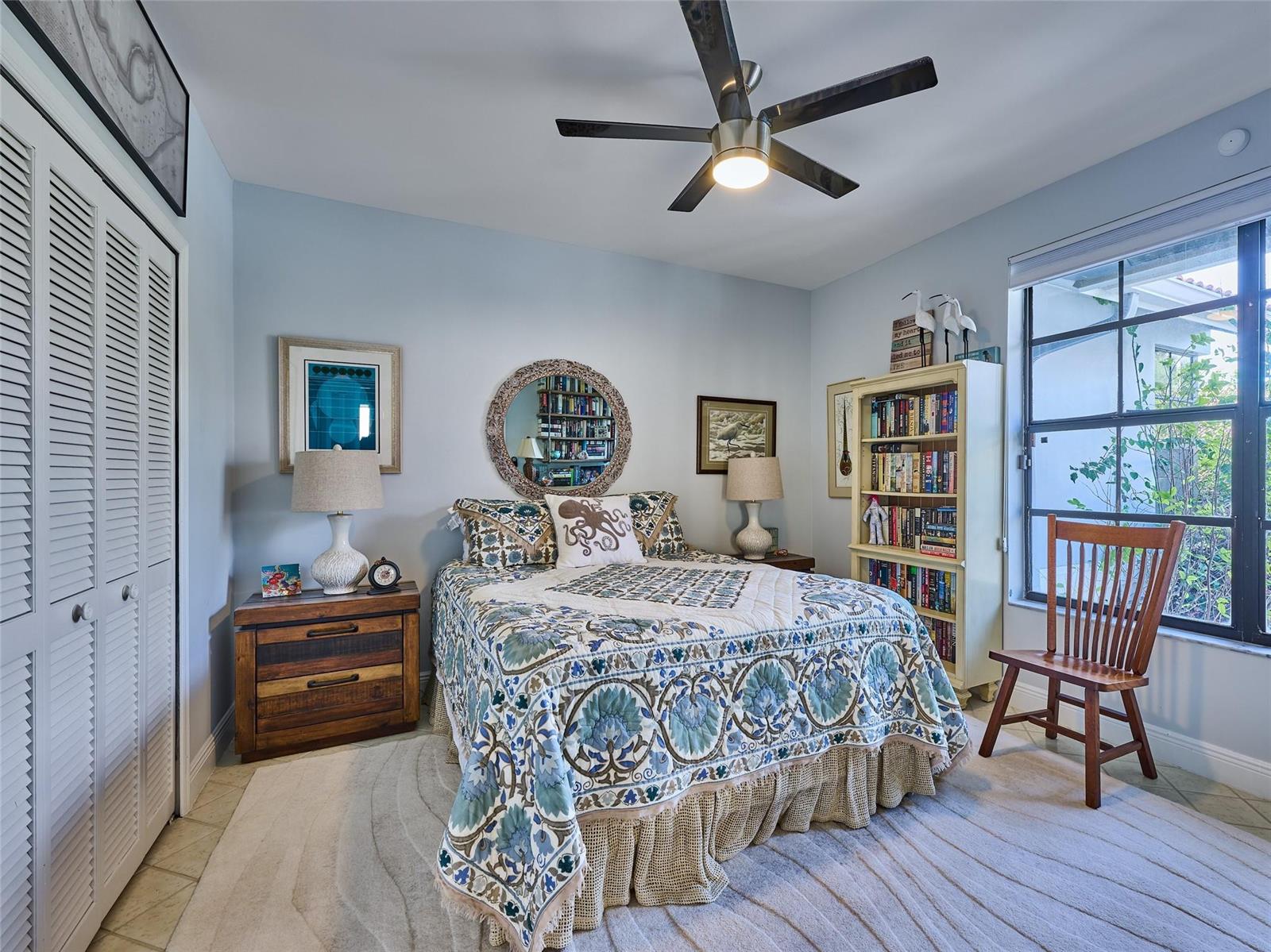 A bedroom features a bed with a patterned quilt, a wooden nightstand, and a bookshelf — 19284 Cherry Hills Terrace, Boca Raton FL 33498, BOCA RATON, FL