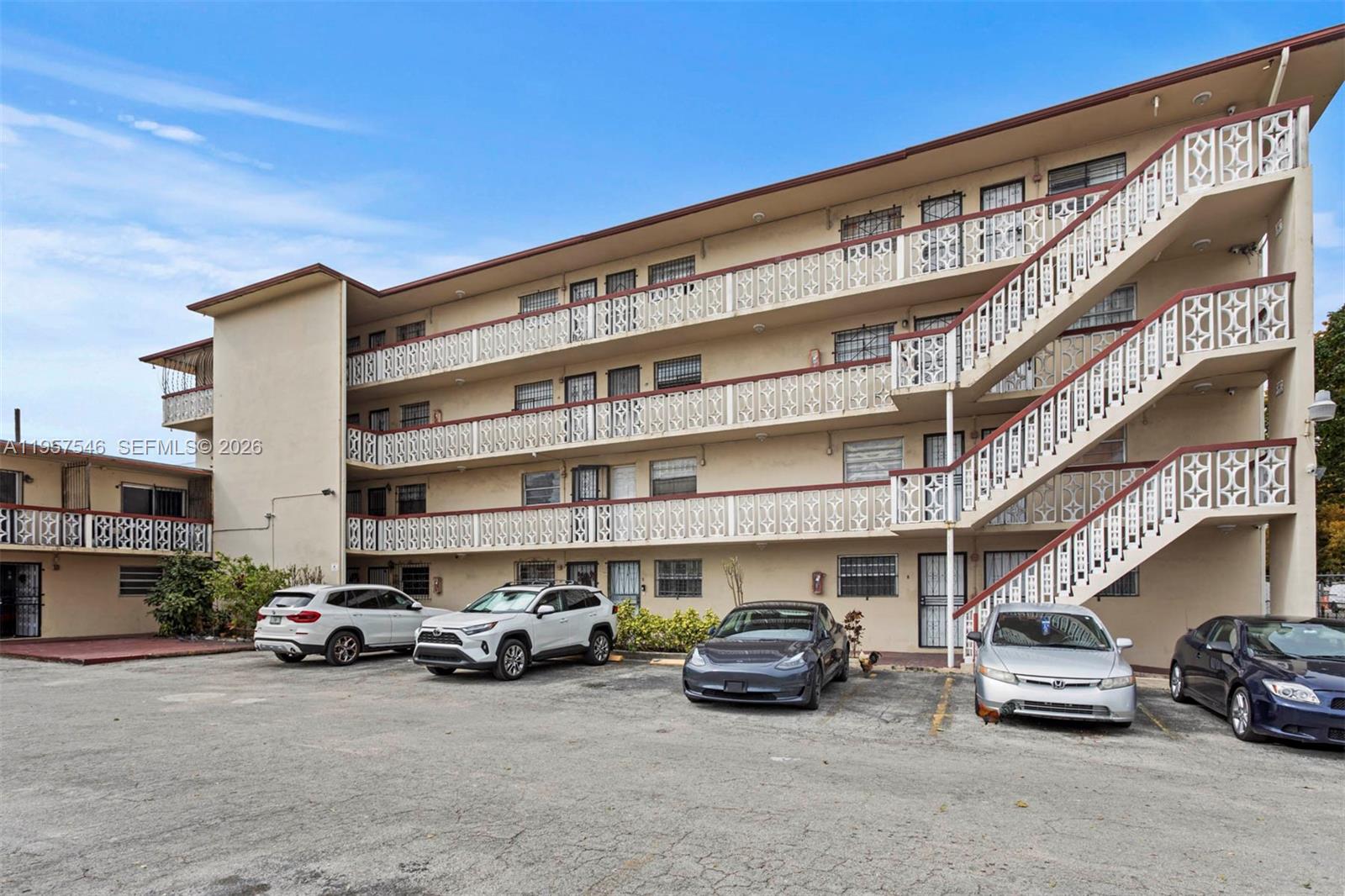 A multi-story apartment building features exterior staircases and a paved parking lot in front — 1220 SW 5th St # 21, Miami FL 33135, MIAMI, FL