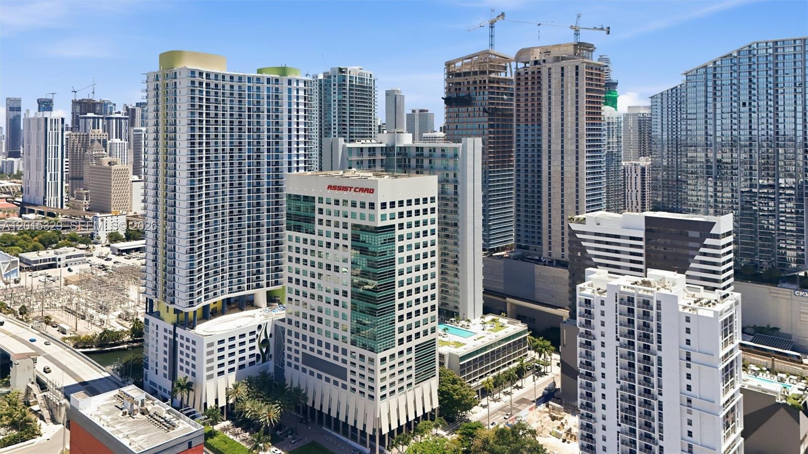 An aerial view of a dense urban skyline featuring several high-rise apartment and office buildings — 175 SW 7th St # 1614, Miami FL 33130, MIAMI, FL