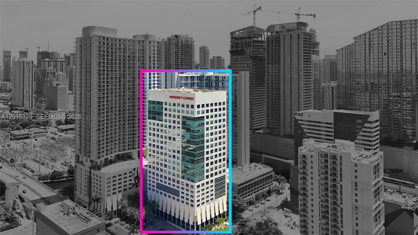 An aerial view highlights a white high-rise office building with a blue glass facade — 175 SW 7th St # 1614, Miami FL 33130, MIAMI, FL