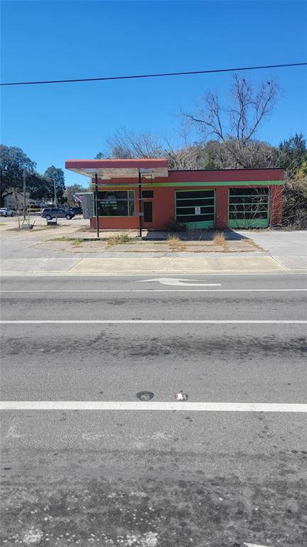 A vacant, single-story commercial building with a flat roof and green-trimmed garage bays — 10 NW 250TH STREET, NEWBERRY, FL