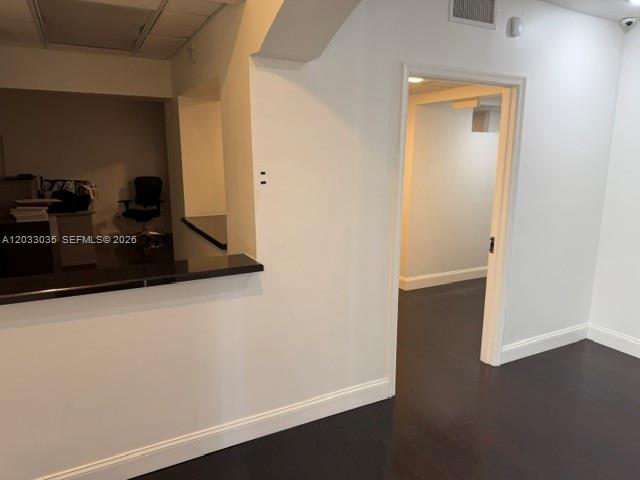 An office interior features a dark wood counter, white walls, and a doorway leading to another room — 4627 Ponce De Leon Blvd, Coral Gables FL 33146, CORAL GABLES, FL