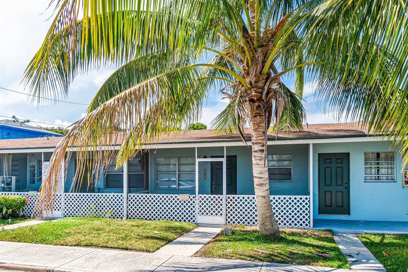 A single-story house with a palm tree, white lattice fencing, and a concrete walkway — 504 9th Avenue N # 508, FL 33460, FL