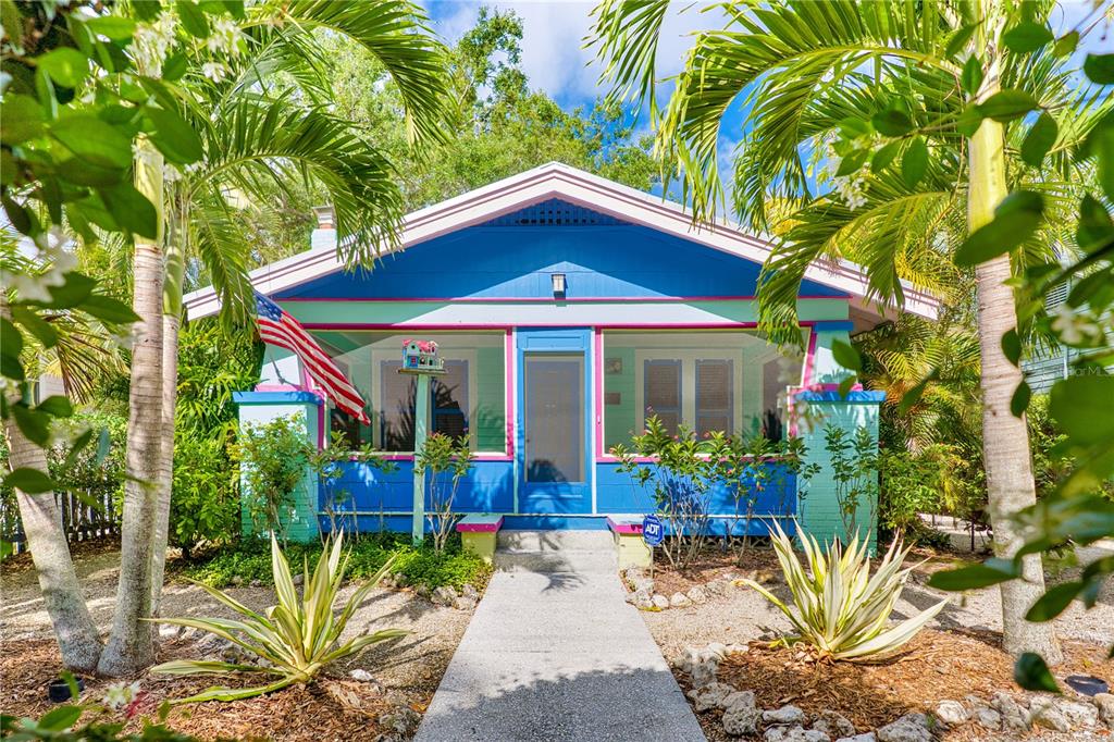 A colorful blue and mint green bungalow features a front porch and a gravel yard — 642 OHIO PLACE, SARASOTA, FL