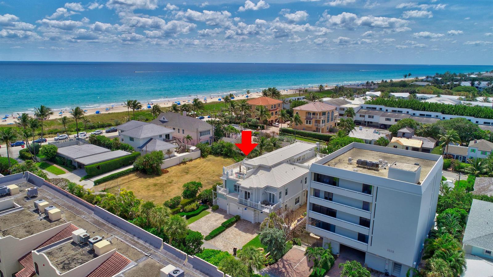 An aerial view shows a multi-story house with a rooftop deck near the ocean — 1120 Ocean Terrace, Delray Beach FL 33483, DELRAY BEACH, FL