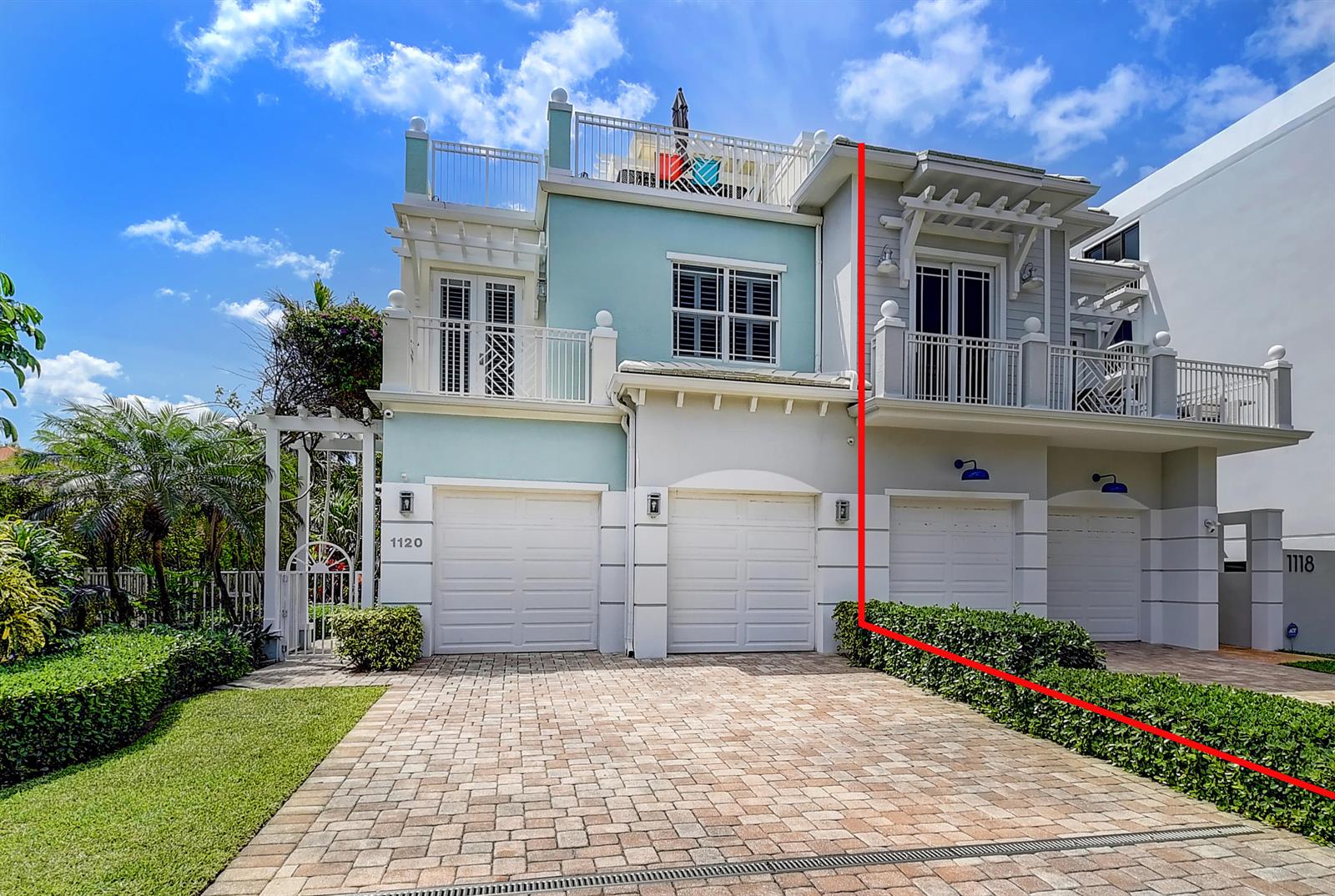 The exterior of a multi-story townhouse with a paved driveway and a rooftop deck — 1120 Ocean Terrace, Delray Beach FL 33483, DELRAY BEACH, FL