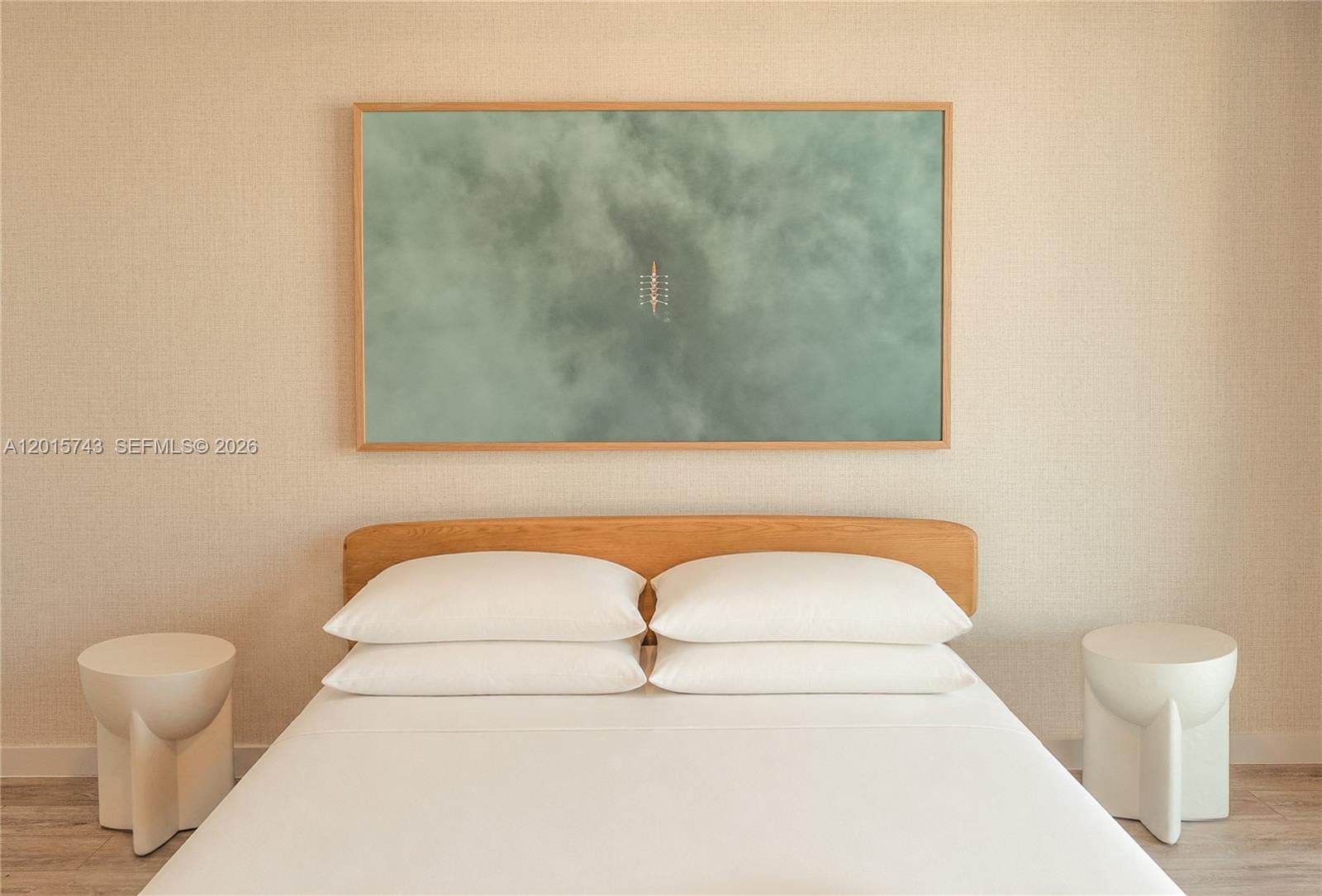A bedroom features a bed with white linens, a wooden headboard, and a large framed artwork — 275 SW 6th St # 5307, Miami FL 33130, MIAMI, FL