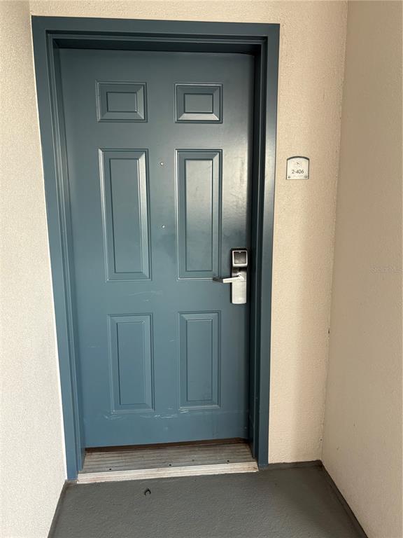 A blue front door with a digital lock and unit number 2-406 — 13427 BLUE HERON BEACH DRIVE UNIT 406, ORLANDO, FL