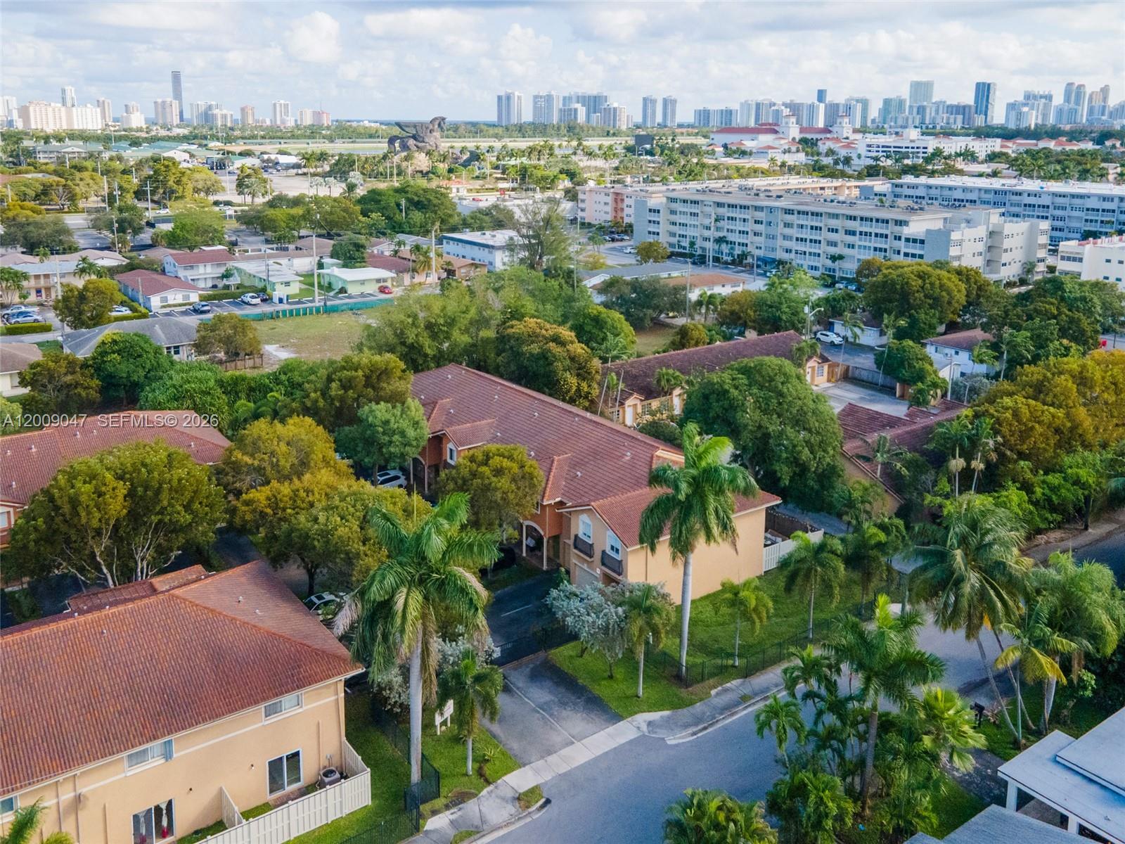 An aerial view shows a residential complex with tile roofs surrounded by palm trees — 59 SE 3rd Ave # 59, Hallandale Beach FL 33009, HALLANDALE BEACH, FL