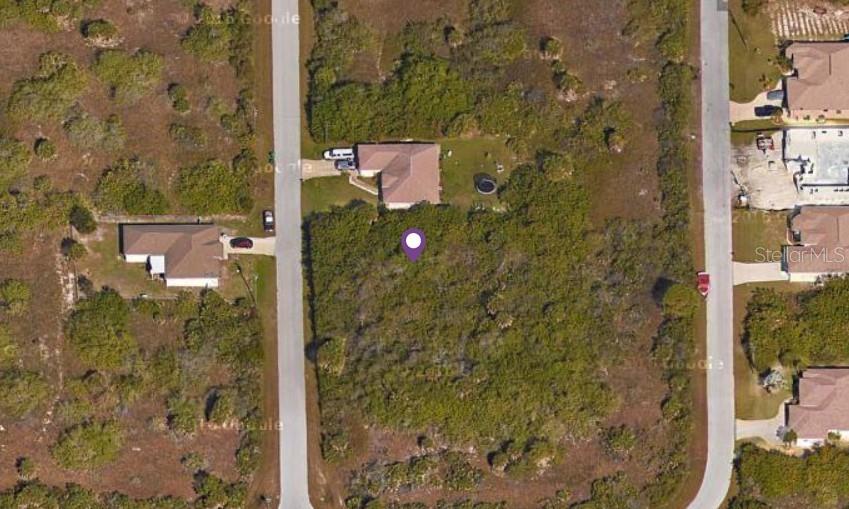 This aerial map view shows a vacant, wooded residential lot located between two paved streets — 10472 PENSACOLA STREET, PORT CHARLOTTE, FL