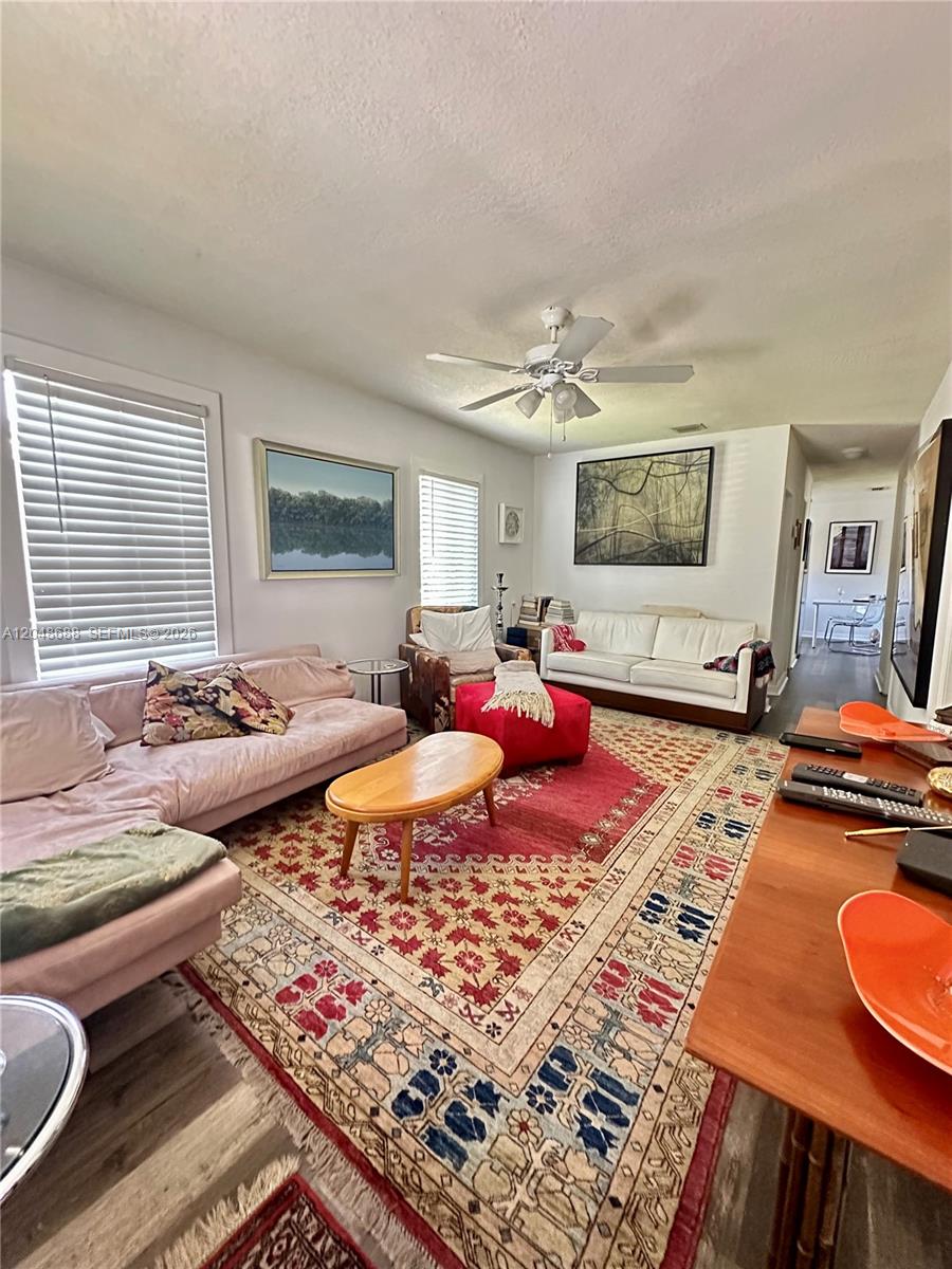 A living room features a patterned area rug, two sofas, an armchair, and a coffee table — 3611 OAK AV, Miami FL 33133, MIAMI, FL