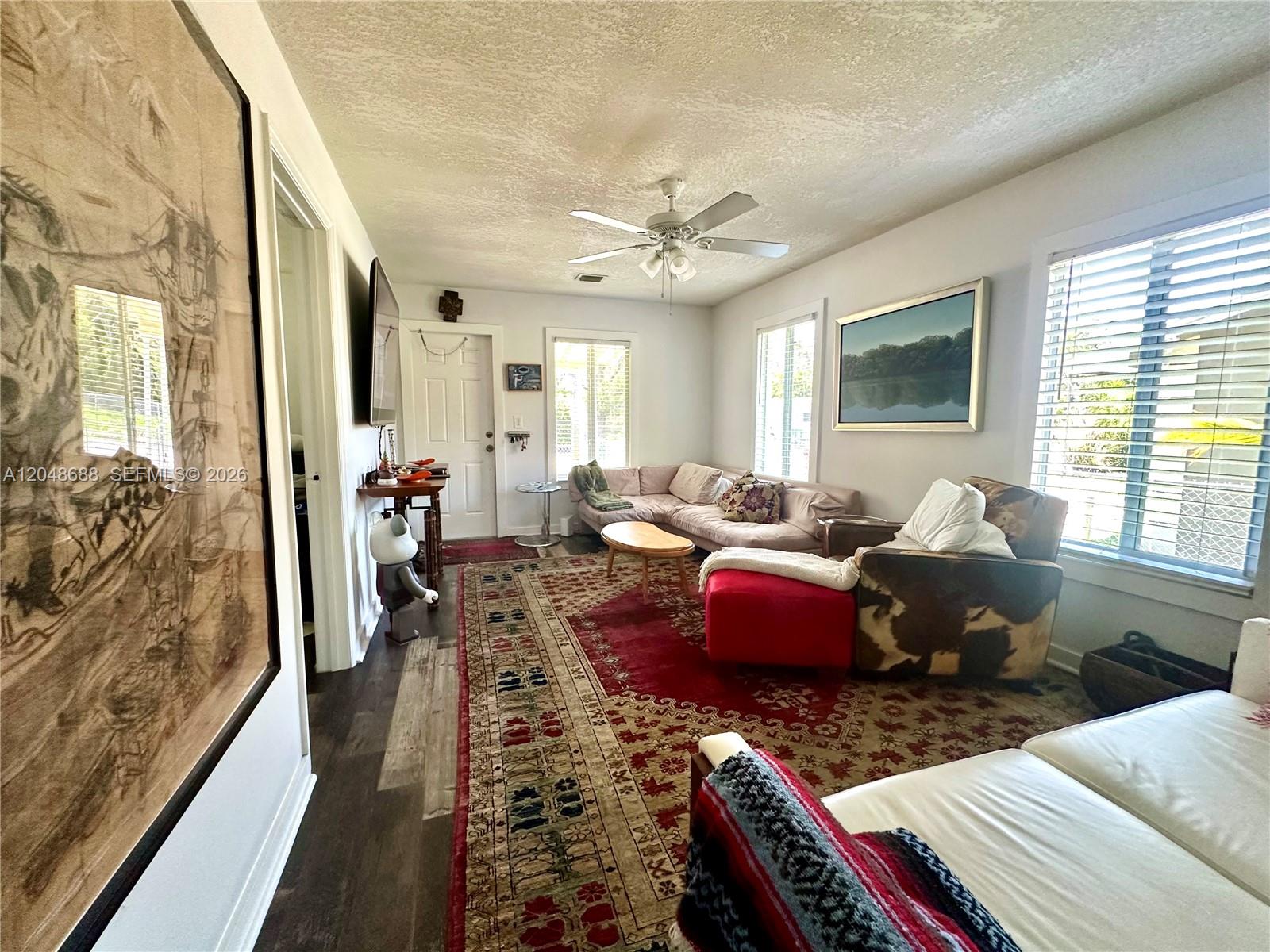 A living room features a large red patterned rug, a sectional sofa, and a ceiling fan — 3611 OAK AV, Miami FL 33133, MIAMI, FL
