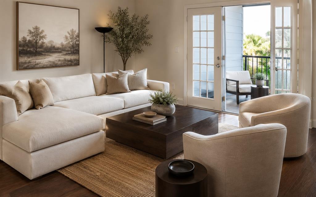 A living room features a cream sectional sofa, two armchairs, and a dark wood coffee table — 204 E SOUTH STREET UNIT 3060, ORLANDO, FL