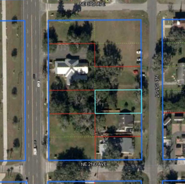 An aerial map view shows a large rectangular property parcel outlined in blue with interior lot divisions — Lot 8 NE 1ST STREET, WILLISTON, FL