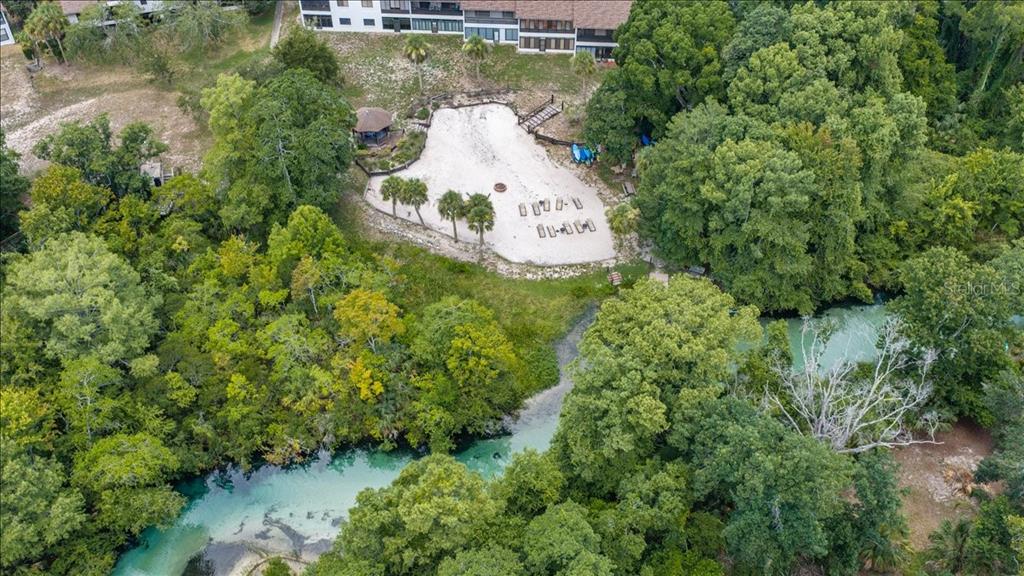 An aerial view shows a sandy beach area with a gazebo next to a river — 6653 RIVER RUN BOULEVARD UNIT 6653, WEEKI WACHEE, FL