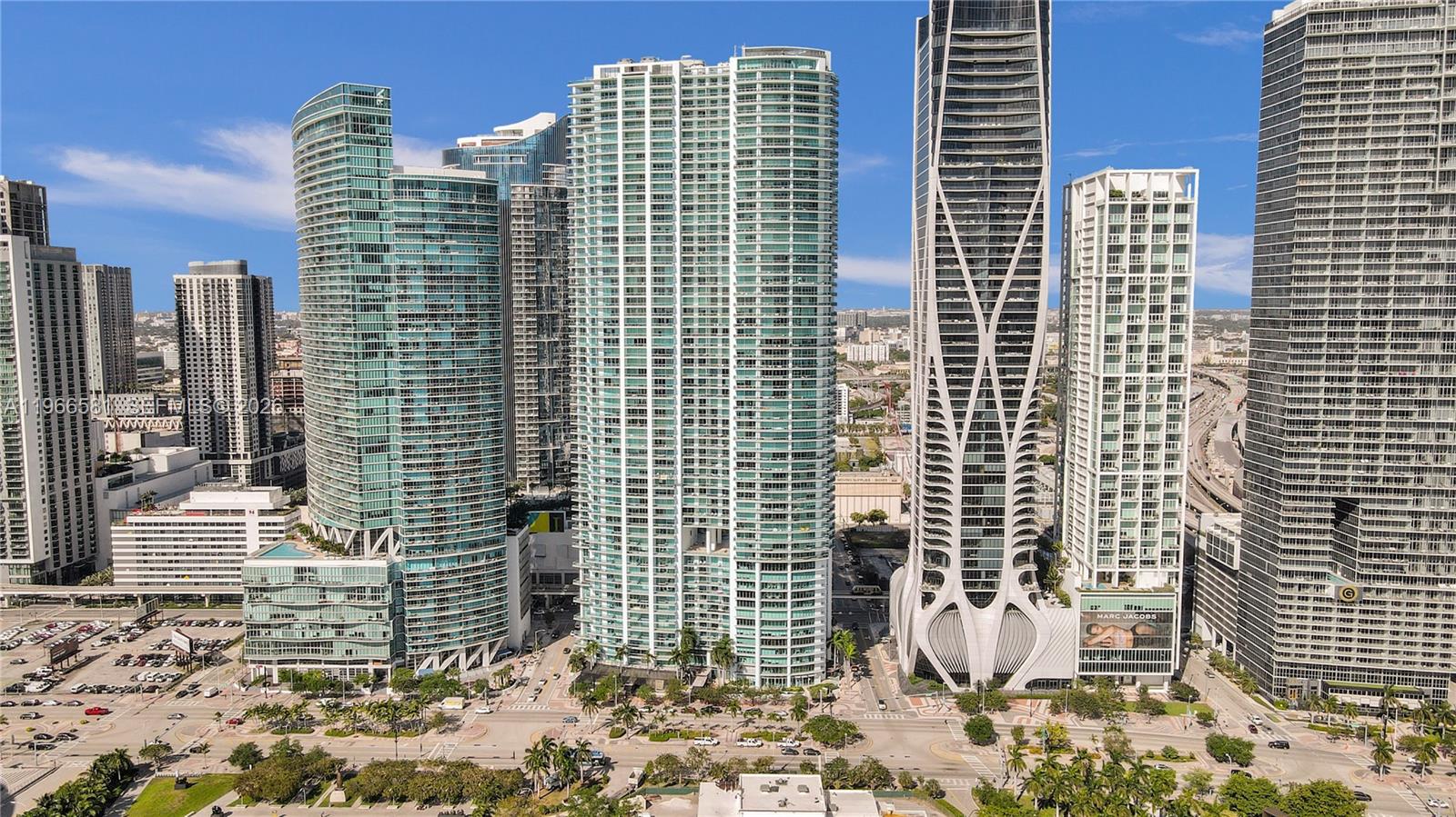 An exterior view of several modern high-rise residential towers in a city skyline — 900 Biscayne Blvd # 2907, Miami FL 33132, MIAMI, FL