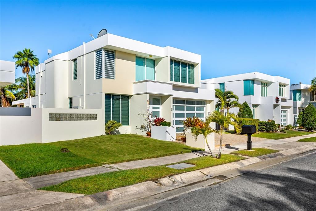 A modern, two-story white house with a flat roof and a manicured front lawn — D-44 CALLE AMATISTA, DORADO, PR