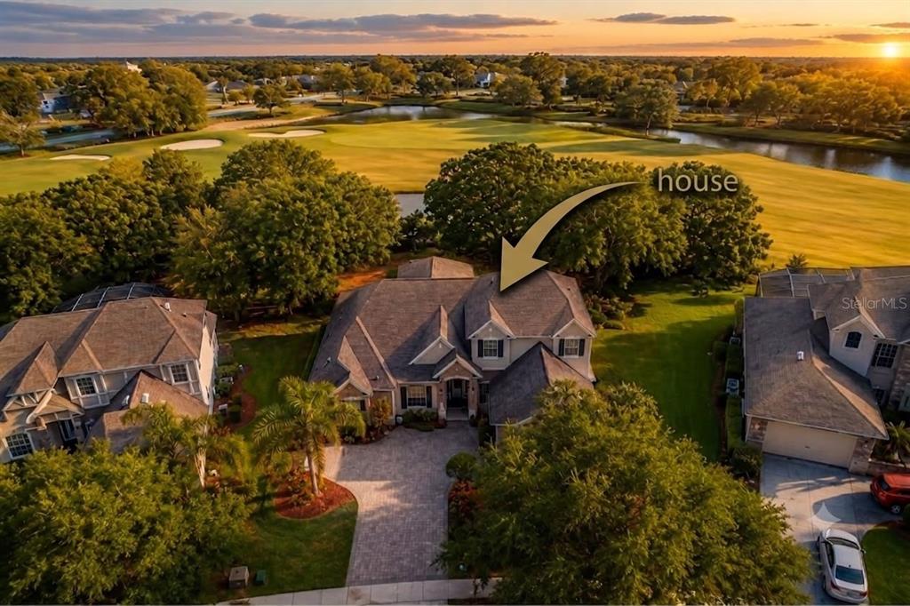 An aerial view shows a suburban house with a paved driveway facing a golf course — 1724 BRIDGETS COURT, KISSIMMEE, FL