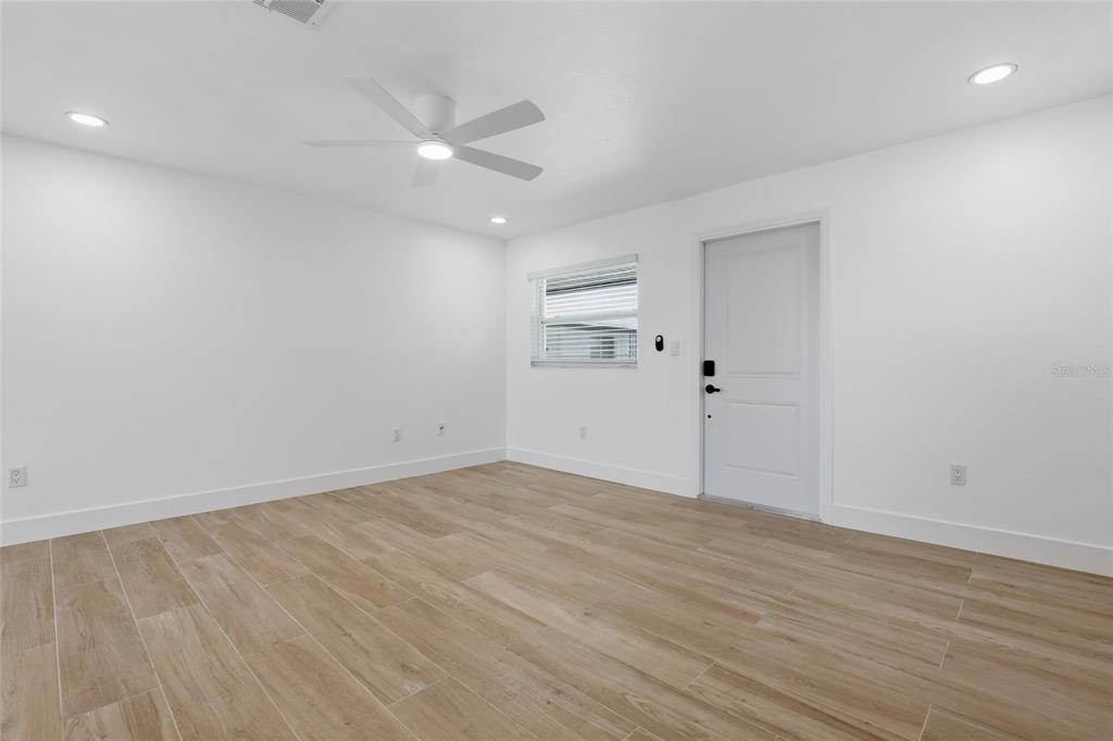 An empty room with white walls, recessed lighting, a ceiling fan, and wood-look tile flooring — 4460 OAKLEY STREET, PUNTA GORDA, FL