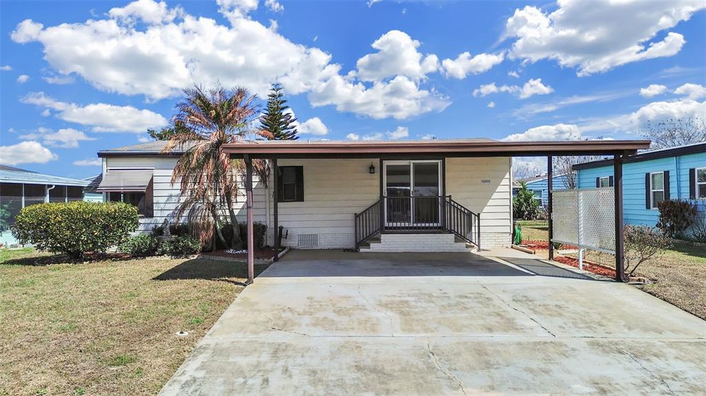 A single-story house with a concrete driveway, a carport, and a small front porch — 4969 DEERWOOD DR, LAKELAND, FL