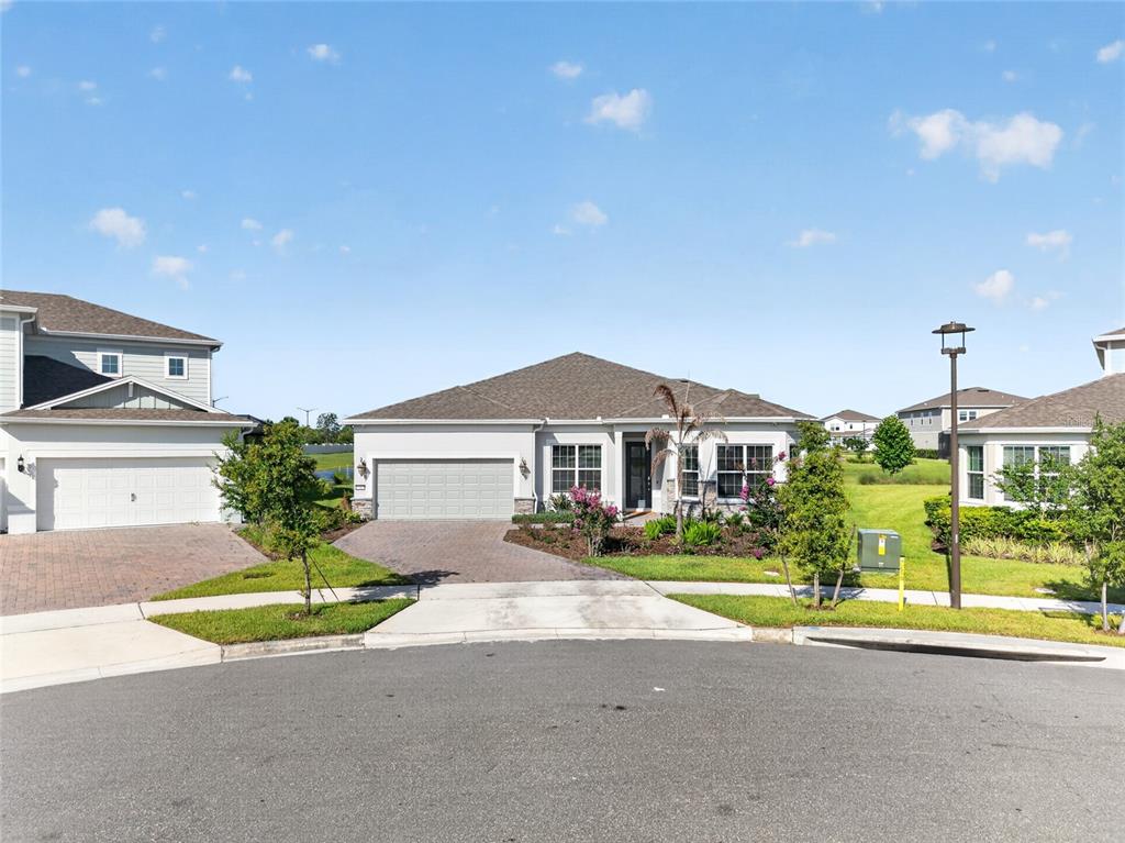A single-story suburban house with a gray garage and a paved driveway — 13207 PANAMA BEACH COURT, ORLANDO, FL