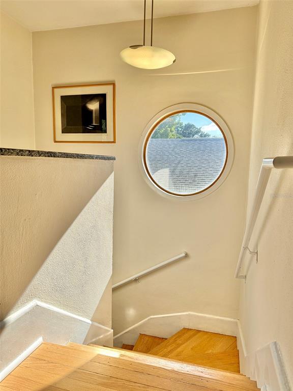 A bright hallway with white marble-look tile floors leads into an adjacent living area — 237 20TH AVENUE SE, ST PETERSBURG, FL