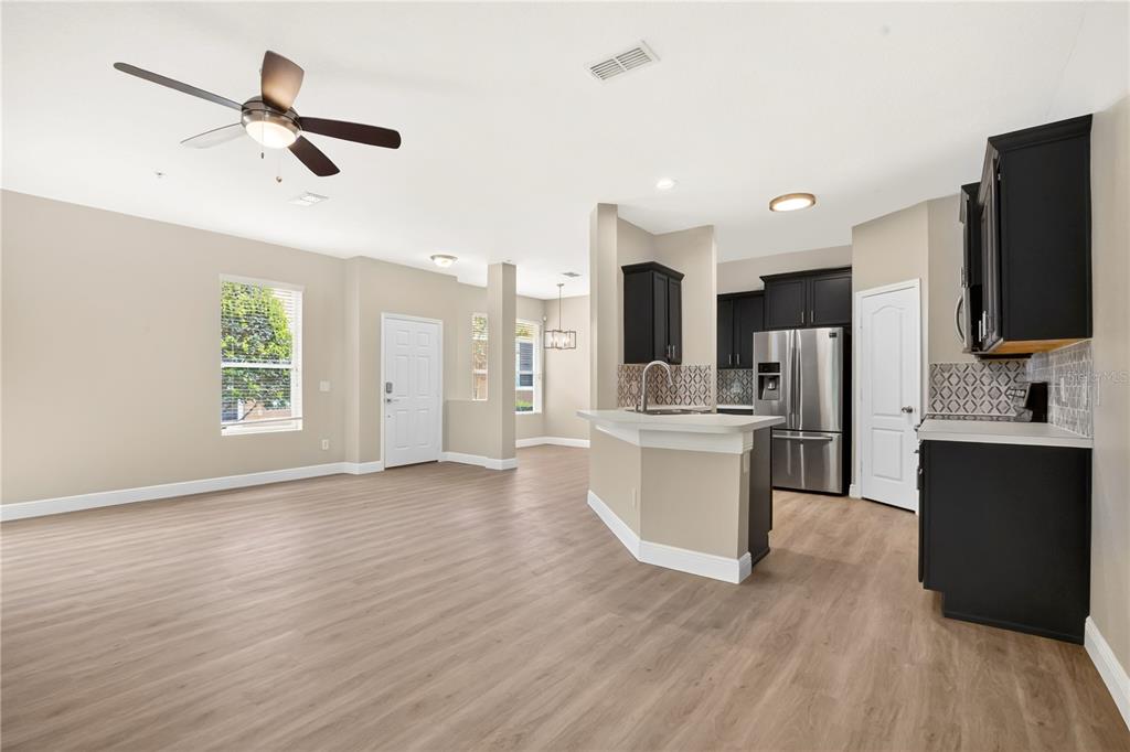 A dining room features a marble-topped table, six upholstered chairs, and a modern chandelier — 15357 OAK APPLE COURT UNIT 4C, WINTER GARDEN, FL