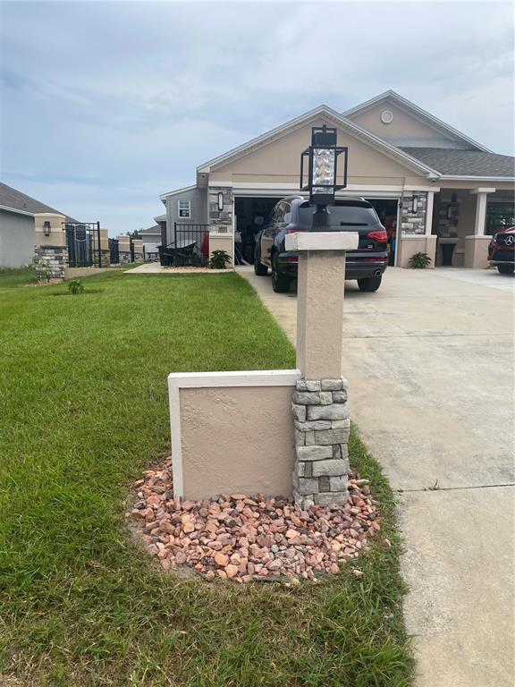 A single-story house with a driveway and a portable storage container sits on a corner — 524 CENTRAL RIDGE LANE, FROSTPROOF, FL