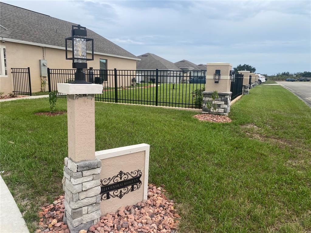 A single-story house with a concrete driveway, a front porch, and a small lawn — 524 CENTRAL RIDGE LANE, FROSTPROOF, FL