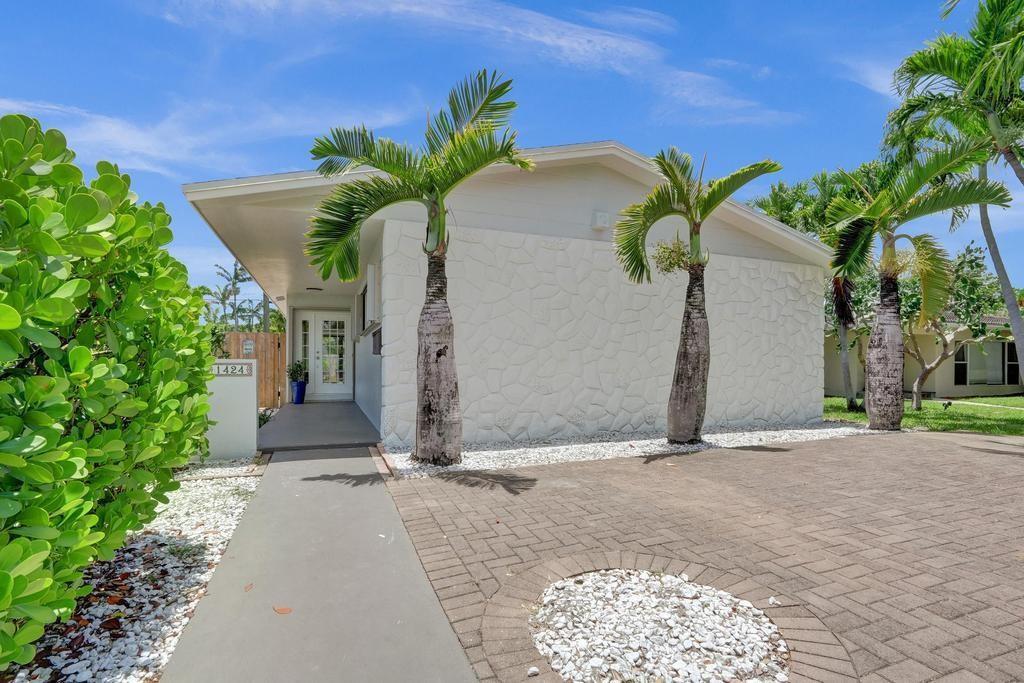 A single-story house with a white stone facade, palm trees, and a paved driveway — 1424 Adams Street, Hollywood FL 33020, HOLLYWOOD, FL