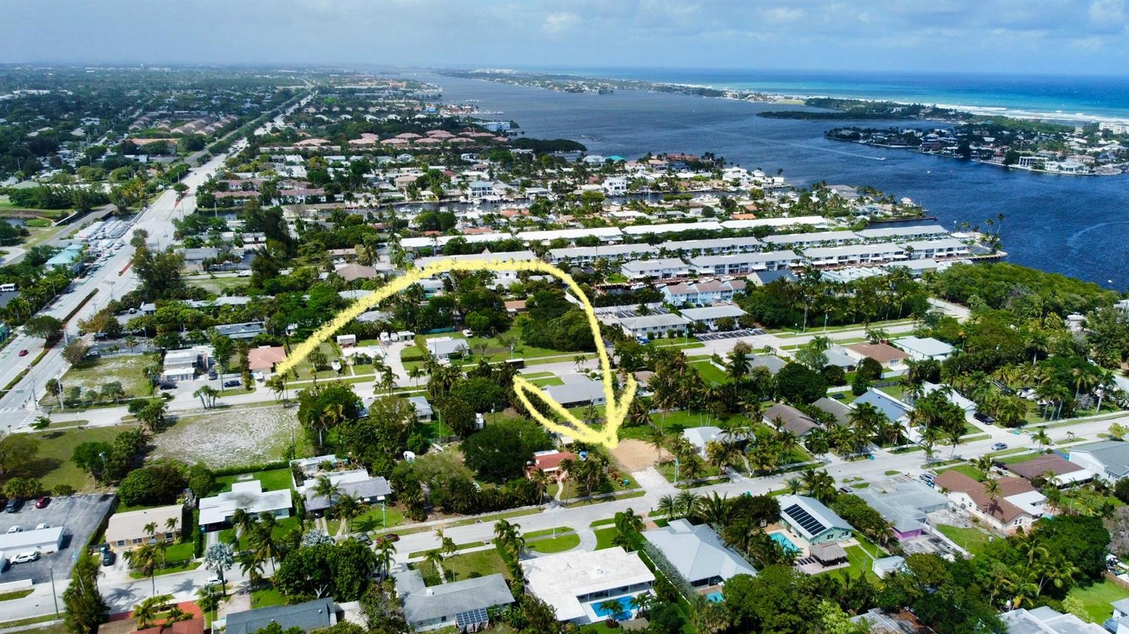 An aerial view shows a residential neighborhood with a yellow arrow pointing to a vacant lot — 647 NE 9th Avenue, Boynton Beach FL 33435, BOYNTON BEACH, FL